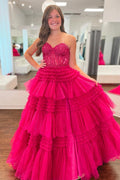 Vestido de fiesta largo de tul fucsia con apliques multicapa sin tirantes y corte A